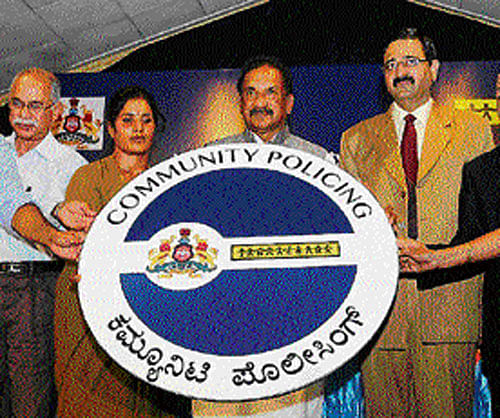 Experimental initiative: Home Minister K J George launches  the Community Policing  programme in Bangalore on Thursday.  dh photo