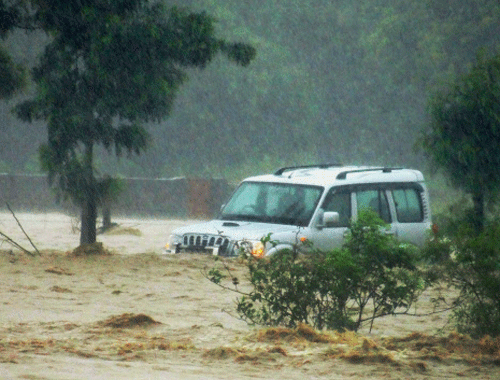 A vehicle submerged in flood in Uttarkashi following incessant rains. PTI Photo.