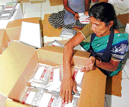 Helping hand: Staff at the Defence Food Research Laboratory in Mysore on Friday packing ready-to-eat food packets for pilgrims stranded in the flood-ravaged Uttarakhand. KPN