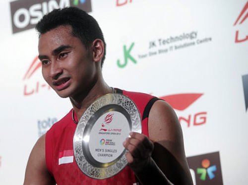 Indonesia's Tommy Sugiarto poses in the victory ceremony of the men's singles finals at the Singapore Badminton Open, Sunday, June 23, 2013 in Singapore. Sugiarto beat Thailand's Boonsak Ponsana, 20-22, 21-5, 21-17 in the finals to win the competition. AP Photo.