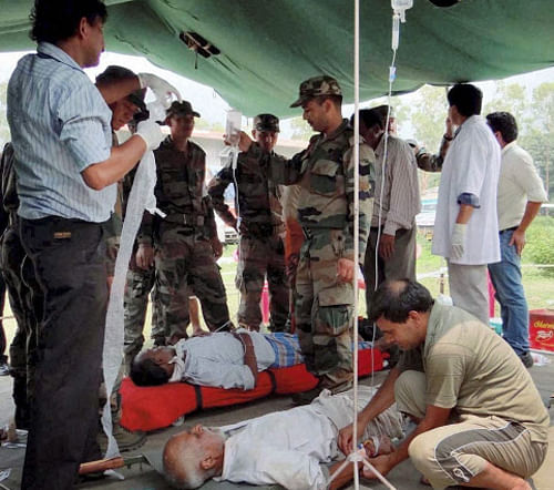 Rescued pilgrims being given medical aid by the Army at a relief camp at Gauchar in Chamoli on Saturday. PTI Photo
