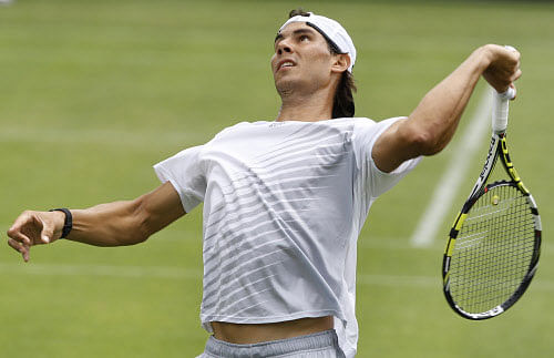 Rafael Nadal of Spain plays a return during a training session at the Wimbledon tennis championships in London, Sunday, June 23, 2013. The Championships start Monday, with defending men's champion Roger Federer of Switzerland attempting to win the title for the eighth time. (AP Photo