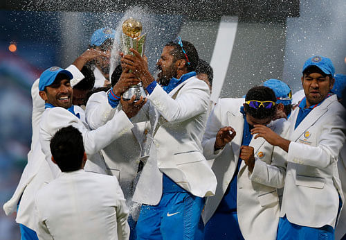 India's players celebrate with the trophy after their win against England at the end of their ICC Champions Trophy final cricket match at Edgbaston cricket ground in Birmingham, England, Sunday, June 23, 2013. (AP Photo