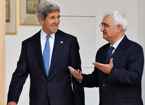 Foreign Minister Salman Khurshid (R) speaks with U.S. Secretary of State John Kerry before their meeting in New Delhi June 24, 2013. Kerry is on a three-day visit to India. REUTERS