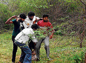 Muniraju, injured in the attack, being shifted to safety.&#150;