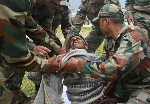 A man cries in pain as he is carried away by soldiers from an army helicopter during a rescue operation at Joshimath in the Himalayan state of Uttarakhand reuters Image