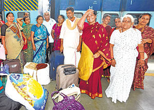 Safe return: Pilgrims from Goudagere village in Mandya district arrive at the City Railway Station by a special train from Delhi on Monday. dh photo