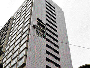 Disaster averted: Metal sheets affixed to the side of the JW Marriott building on Vittal Mallya Road, came crashing down due to heavy winds on Monday. No one was injured. KPN