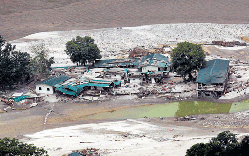 Ahandout provided by the Defence Ministry on Sunday showsdamaged houses next to a river in Uttarakhand. REUTERS
