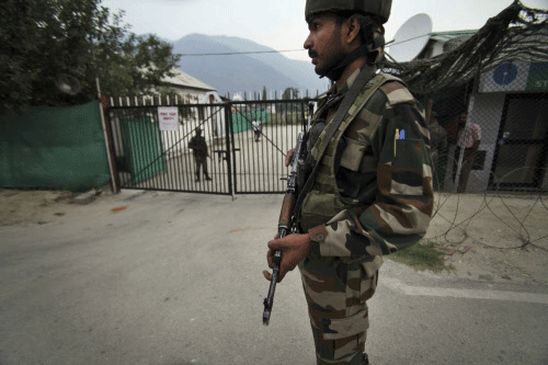 Army soldiers patrol near the venue where Prime Minister Manmohan Singh is said to inaugurate a hydro power project on June 25, in Kishtwar, India, Monday, June 24, 2013. Five soldiers were killed and seven others wounded Monday in an attack by suspected rebels on an army convoy in Indian-controlled Kashmir on the eve of a visit by Prime Minister Manmohan Singh. AP photo