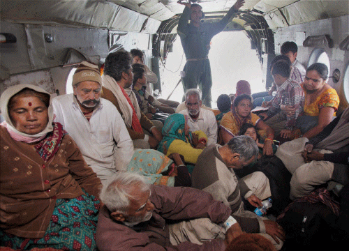 Pilgrims rescued from Kedarnath sit in IAF helicopter at Gupt Kashi in Uttarakhand on Sunday. PTI