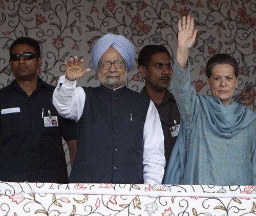 Prime Minster Manmohan Singh, left front, and Congress Party President Sonia Gandhi, wave to the crowd during the foundation stone lying ceremony of the 850 MW Rattle hydro power project in Kishtwar district of the Jammu region in India, Tuesday, June 25, 2013. Shops, businesses and schools were closed in Indian-controlled Kashmir after separatist groups called for a strike Tuesday to protest a visit by the Indian prime minister to the disputed Himalayan region. AP photo