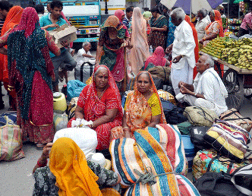 Rescued Rajasthani pilgrims wait to depart for Dehradun in Uttarkashi on Monday. PTI Photo