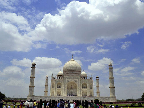 Clouds hover in the sky over the historic Taj Mahal in Agra on Saturday. PTI Photo