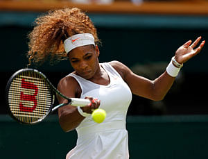 Serena Williams of the United States plays a return during her Women's first round singles match against Mandy Minella of Luxembourg at the All England Lawn Tennis Championships in Wimbledon, London, Tuesday, June 25, 2013. (AP Photo