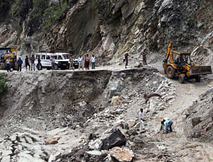 Local authorities clear a damaged road caused by landslides in Gauchar, Uttarakhand on Tuesday. PTI Photo