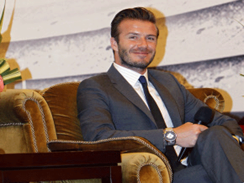 In this photo released by China's Xinhua News Agency, soccer superstar David Beckham smiles during a news conference in Shanghai, China, Thursday, June 20, 2013. Fans eager to see Beckham stormed a police cordon Thursday in a stampede at a Shanghai university that injured seven people including five security personnel. AP Photo