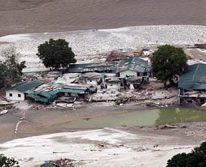 A view shows the damaged houses next to a river after heavy rains in the Himalayan state of Uttarakhand in this June 23, 2013 handout provided by the Indian Ministry of Defence. Flash floods and landslides unleashed by early monsoon rains have killed at least 560 people in Uttarakhand and left tens of thousands missing, officials said on Saturday, with the death toll expected to rise significantly. Picture taken June 23, 2013. REUTERS