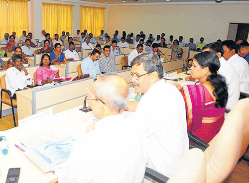 ZP President Upendra Nayak chairs the Zilla Panchayat meeting in Udupi on Tuesday. ZP CEO Prabhakar Sharma among others look on. DH Photo