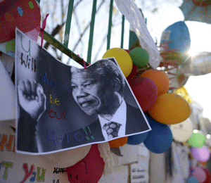 A photograph of former South African President Nelson Mandela with a handwritten message 'You will always be our hero', is attached to the wall of his Medi-Clinic Heart Hospital where he is being treated in Pretoria June 26, 2013. REUTERS