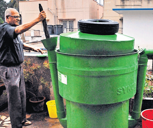 Proactive: NS Ramakanth filling the biogas plant with kitchen waste.