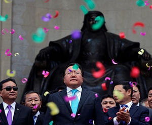 Mongolia's President Tsakhia Elbegdorj (C) celebrates his re-election with members of his cabinet and party in front of the statue of Genghis Khan, at