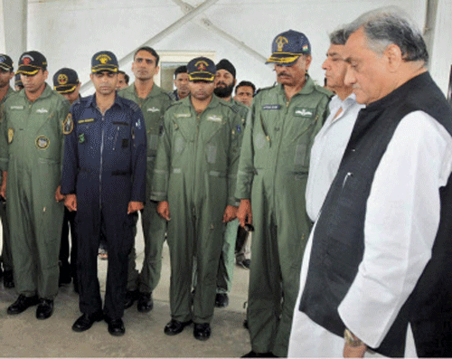 Uttarakhand CM Vijay Bahuguna with IAF soldiers observes a 2-minutes silence for the crew members of MI-17 helicopter that crashed during rescue operation, during a visit to an IAF relief camp in Dehradun on Wednesday. PTI Photo