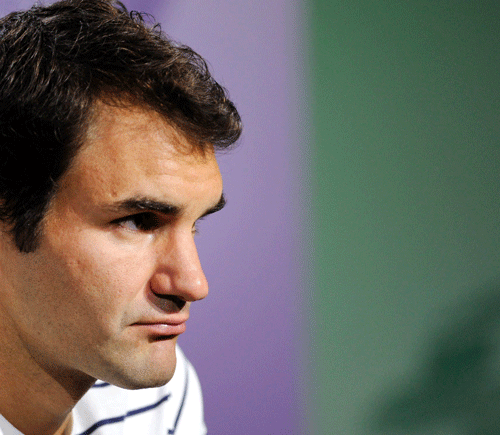 Roger Federer of Switzerland pauses during a press conference after his defeat to Sergiy Stakhovsky of Ukraine in a Men's second round singles match at the All England Lawn Tennis Championships, Wimbledon, London, Wednesday, June 26, 2013. AP Photo.