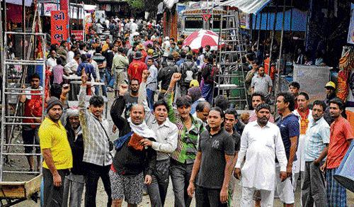 Amarnath pilgrims shout religious slogans on their arrival at Nunwan Base Camp in Pahalgam on Thursday. PTI