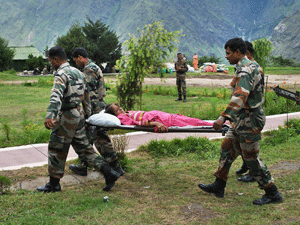 Joshimath: Army soldiers carry an injured pilgrim on a stretcher at Joshimath in Uttarakhand on Friday. PTI Photo