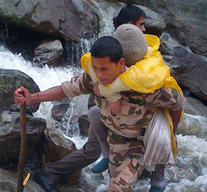An ITBP jawan rescuing a flood-victim near Badrinath in Utrakhand on Thursday. PTI Photo