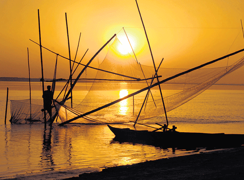 Soothing sight: A fisherman casts his net in the Brahmaputra at Silghat in Assam (Photo by wikimedia commons) (Photo by authors).