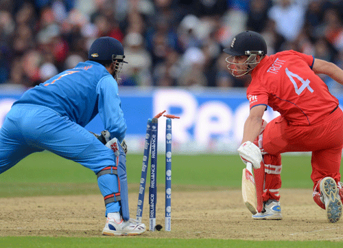 File Photo: England's Jonathan Trott looks back to see that he is stumped by India's Mahendra Singh Dhoni during the ICC Champions Trophy final cricket match at Edgbaston cricket ground, Birmingham June 23, 2013. REUTERS