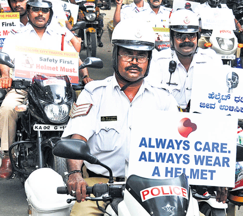 Traffic police take out a bike rally to create awareness on  wearing helmet, in the City on Saturday. DH Photo