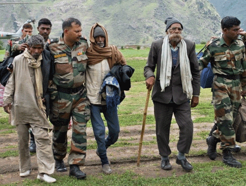 Army soldiers rescue pilgrims at Joshimath in Uttarakhand. PTI Photo