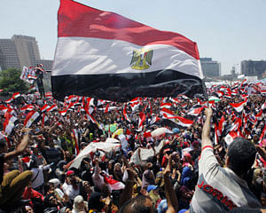 Egyptians chant slogans and wave national flags during a protest in Tahrir Square, the focal point of Egyptian uprising, in Cairo Sunday, June 30, 2013. Organizers of a mass protest against Egyptian President Mohammed Morsi claimed Saturday that more than 22 million people have signed their petition demanding the Islamist leader step down, asserting that the tally was a reflection of how much the public has turned against his rule. AP Photo