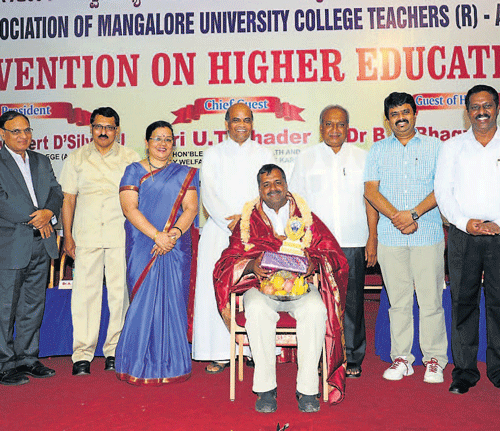 Health and Family Welfare Minister U T Khader accepts felicitation at the Higher Education Convention organised by AMUCT at Eric Mathias Hall in St Aloysius College in Mangalore on Sunday. dh photo