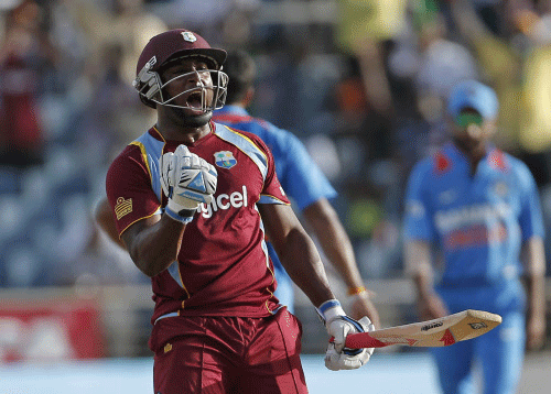 West Indies' Tino Best celebrates after his batting partner Kemar Roach, unseen, scored the wining run off India's bowler Umesh Yadav during their Tri-Nation Series cricket match in Kingston, Jamaica, Sunday, June 30, 2013. The West Indies won by 1 wicket with 14 balls remaining. AP photo