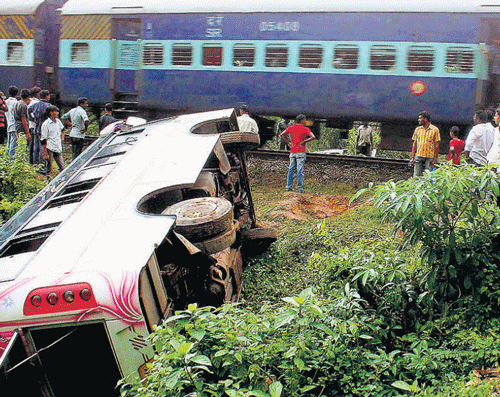 knocked down: The mini bus which was hit by a goods train at Adyar Padavu on the outskirts of Mangalore on Sunday. KPN