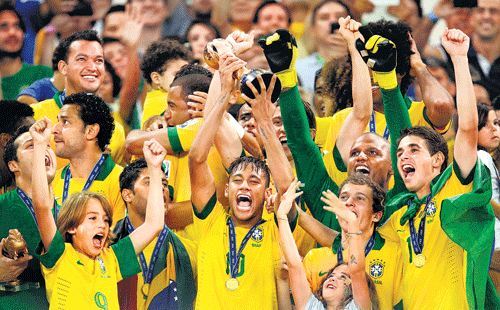little canaries: Brazilian players display the trophy after winning the Confederations Cup on Sunday. reuters