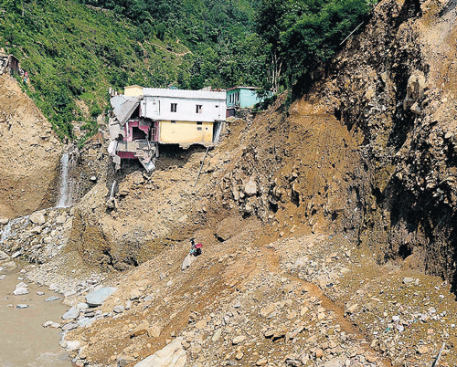 Aftermath: A damaged house perched on a hill at Silli in northern Uttarakhand on Monday. AFP