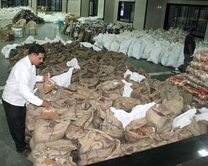 A relief worker arranges material for the victims of Uttarakhand floods in Surat on Monday.PTI Photo
