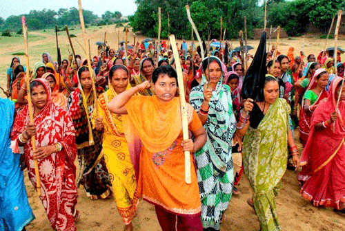 Women holding a protest against the land acquisition work for Posco steel project in Patana village in Paradip district on Tuesday. PTI Photo