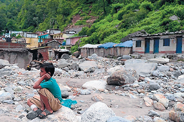 A child contemplates future travails in the wake of the flood at Sonprayag in Uttarakhand on Tuesday. AFP