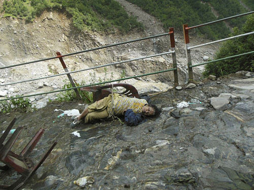 In this undated photograph taken in June 2013 after the floods and landslides, a body of a pilgrim lies on the route to Kedarnath, in the northern Indian state of Uttarakhand. The death toll from devastating floods and landslides that struck nearly two weeks ago in Uttarakhand has exceed 1,000 and thousands of people are still missing. (AP Photo)