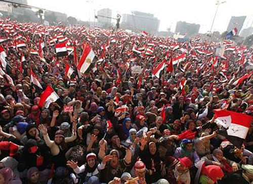 Protesters against Egyptian President Mohamed Mursi wave national flags in Tahrir Square in Cairo July 3, 2013. REUTERS