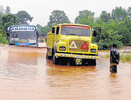 Marooned: Vehicles stranded on the flooded Shimoga-Shikaripur road. dh photos