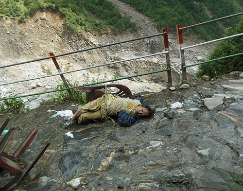 In this undated photograph taken in June 2013 after the floods and landslides, a body of a pilgrim lies on the route to Kedarnath, in the northern Indian state of Uttarakhand. The death toll from devastating floods and landslides that struck nearly two weeks ago in Uttarakhand has exceed 1,000 and thousands of people are still missing. (AP Photo)