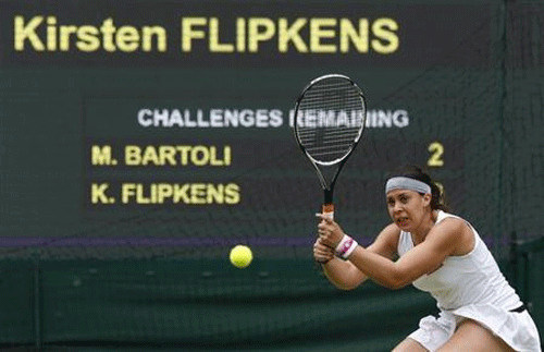 Marion Bartoli of France hits a return to Kirsten Flipkens of Belgium during their women's semi-final tennis match at the Wimbledon Tennis Championships, in London Reuters Image