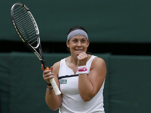 Marion Bartoli of France celebrates after defeating Kirsten Flipkens of Belgium in their women's semi-final tennis match at the Wimbledon Tennis Championships, in London July 4, 2013. REUTERS